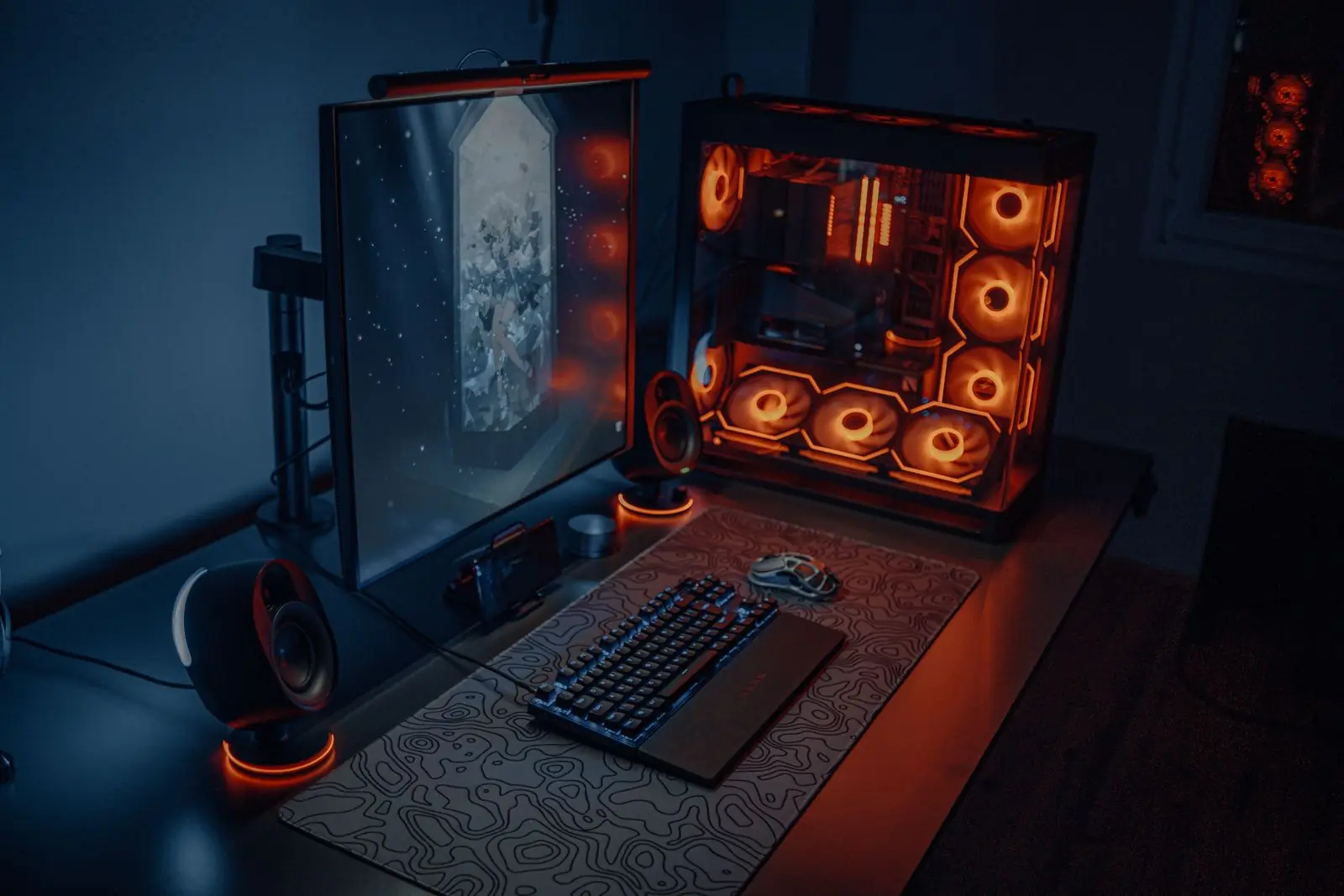 Gaming desk lit with RGB LED strip lighting in a dark room