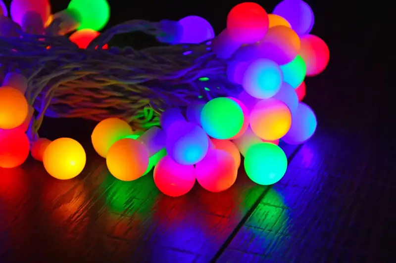 Colorful globe string lights glowing on a table