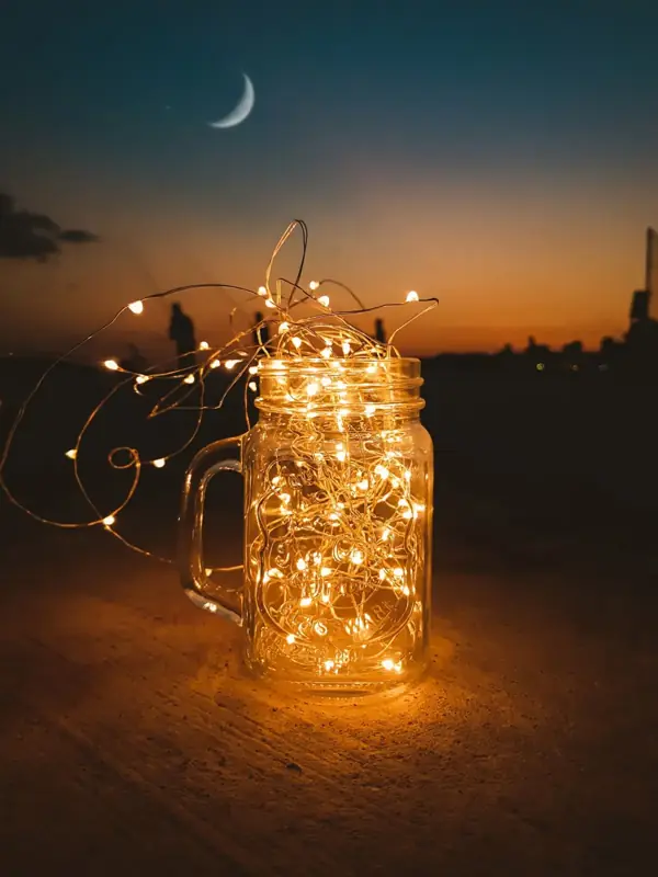Glass jar of fairy lights glowing at twilight