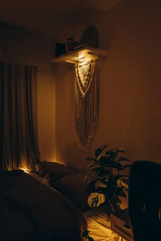 A softly lit bedroom with warm lamp light